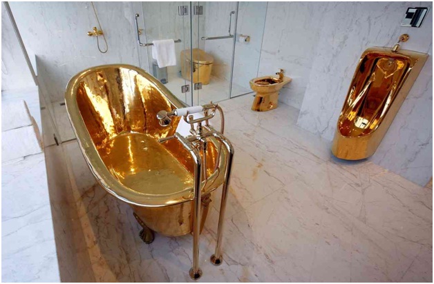 A hotel suite with a bathtub made of gold